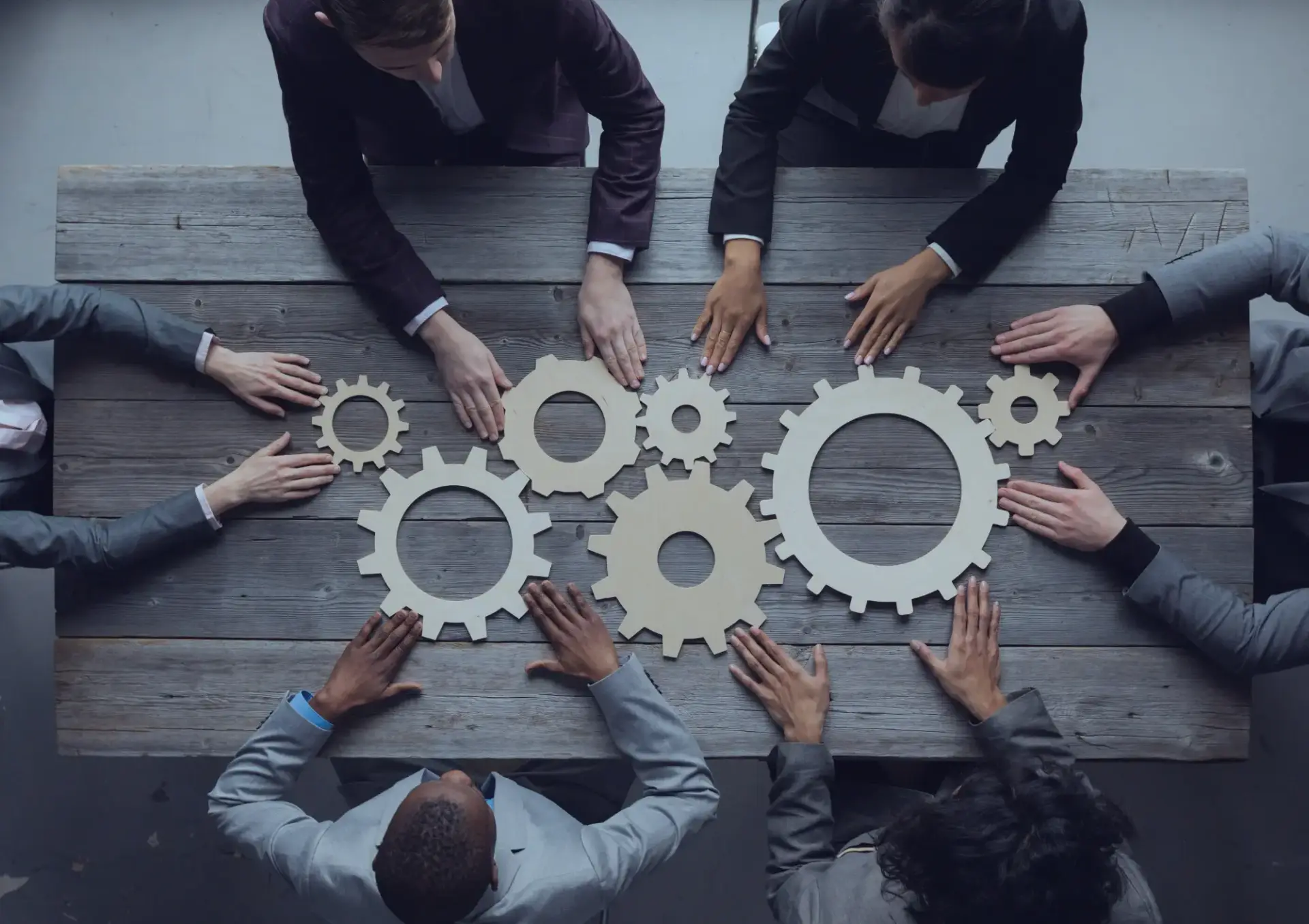 a team people putting gears together